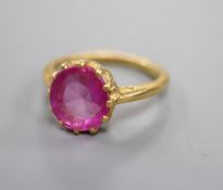 A yellow metal and synthetic? ruby set dress ring, size K/L, gross 4.5 grams.