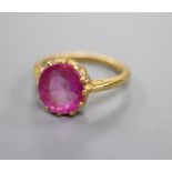 A yellow metal and synthetic? ruby set dress ring, size K/L, gross 4.5 grams.