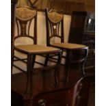 A pair of late Victorian marquetry inlaid mahogany salon chairs