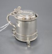 A George V silver mustard pot with blue glass liner, on three recumbent lion feet, Mappin & Webb,