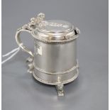 A George V silver mustard pot with blue glass liner, on three recumbent lion feet, Mappin & Webb,