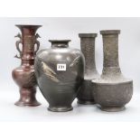 A pair of Japanese bronze vases, a dragon handled bronze vase and a fish decorated bronze vase,