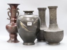 A pair of Japanese bronze vases, a dragon handled bronze vase and a fish decorated bronze vase,