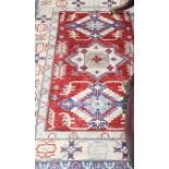 A Turkish Caucasian design brick red ground rug, 180 x 120cm