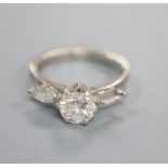 A modern 18ct gold and two (ex three) stone diamond ring, set with central round brilliant cut stone
