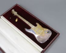 A late 1960's cased parcel gilt silver miniature model of a Fender Stratocaster guitar, maker, TL,