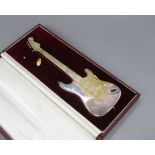 A late 1960's cased parcel gilt silver miniature model of a Fender Stratocaster guitar, maker, TL,