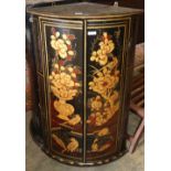 A bow fronted lacquer hanging corner cabinet, W.60cm, D.40cm, H.92cm