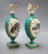 A pair of Coalport green glazed ewers, hand painted birds to the body, height 27cmCONDITION: One