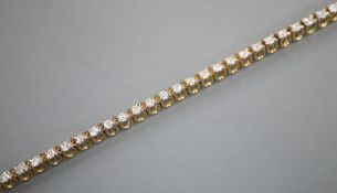 A modern 9ct gold and diamond set line bracelet, 17.7cm, gross 7 grams, approx. weight of each stone