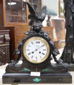 A Victorian malachite black slate mantel clock, with spelter bird surmount