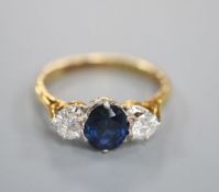 A modern 18ct gold, sapphire and diamond three stone ring, size L, gross 3 grams.CONDITION: Diamonds