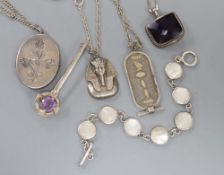 A silver locket on chain, a silver bracelet and other jewellery.