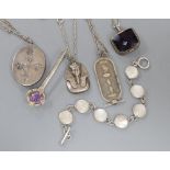 A silver locket on chain, a silver bracelet and other jewellery.