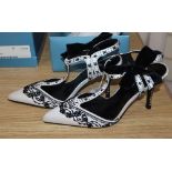 A pair of white satin with black beading Karen Miller T strap shoes with black velvet bows and