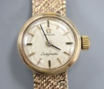 A 9ct gold lady's Omega gold manual wind wristwatch on 9ct gold bracelet, overall length 17.8cm,