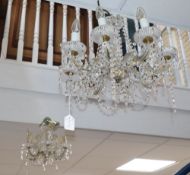 A modern cut glass and brass six-light chandelier and a similar chandelier