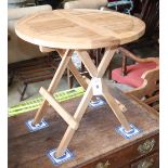 A teak folding garden table, diameter 50cm, H.50cm