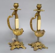 A pair of gilt metal and ivorine sword hilt candlesticks, height 28cm