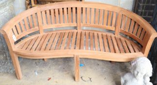 A teak banana garden bench, W.160cm, D.60cm, H.84cm, a.f.