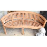 A teak banana garden bench, W.160cm, D.60cm, H.84cm, a.f.