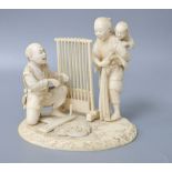 A Meiji ivory okimono of a lady carrying a child and man beside a weaving loom, height 12cm