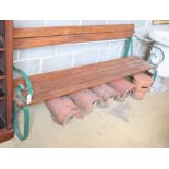 A wrought iron and slatted pine garden bench, W.195cm, D.60cm, H.84cm