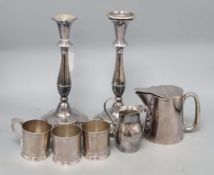A pair of plated candlesticks and sundries, comprising a set of three plated cup/glass holders by