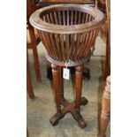 A 1920's mahogany jardiniere, 39cm diameter, H.82cm