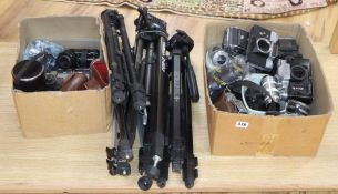 A collection of vintage and other cameras, lenses and stands etc