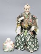 A Japanese ceramic model of a Samurai and a Chinese enamelled ceramic figure of a Buddha, tallest