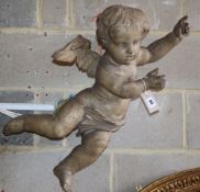 A 19th century carved walnut cherub, L.76cm