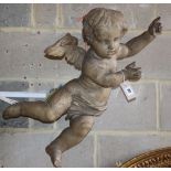 A 19th century carved walnut cherub, L.76cm