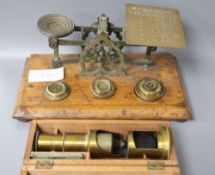 A set of letter scales and a miniature boxed microscope