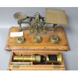 A set of letter scales and a miniature boxed microscope