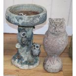 A reconstituted stone garden ornament of an owl, H.38cm, together with a composition bird bath