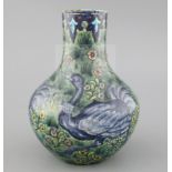 A rare William de Morgan 'Ostrich' bottle vase, c.1888-97, painted by Joe Juster, with a repeating