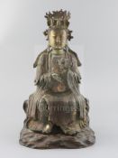 A Chinese lacquered bronze seated figure of Xi Wangmu, late Ming dynasty, holding a cloud in her