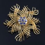A mid 20th century 18ct gold and sapphire set stylised flowerhead brooch, retailed by Regner of