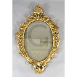 A George III carved giltwood wall mirror, with flowers in a ewer crest and ho-ho birds to each