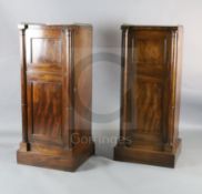 A pair of Regency mahogany inverse breakfront pillar cabinets, with brass three quarter galleries