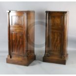 A pair of Regency mahogany inverse breakfront pillar cabinets, with brass three quarter galleries