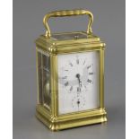 A late 19th century lacquered brass hour quarter repeating carriage alarum clock, with gorge case,