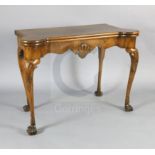 A George I walnut gaming table, with eared serpentine rectangular top, scallop shell carved