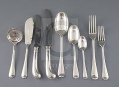 A late Victorian canteen of silver Hanovarian rat tail pattern flatware by Goldsmiths & Silversmiths