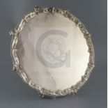 An early George III silver shaped circular salver by Ebenezer Coker, with gadrooned and scroll