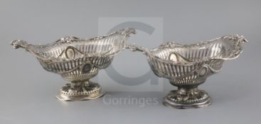 A pair of Victorian pierced silver boat shaped pedestal dishes, maker G.F.?, with swag and roundel