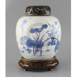 A Chinese blue and white ovoid jar, Kangxi period, painted with egrets amid a lotus pond, double