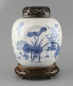 A Chinese blue and white ovoid jar, Kangxi period, painted with egrets amid a lotus pond, double