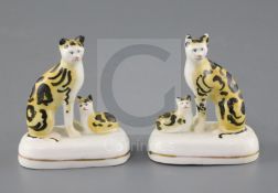 A rare pair of Staffordshire porcelain groups of a cat and a kitten, c.1835-50, H. 7.5 and 7.